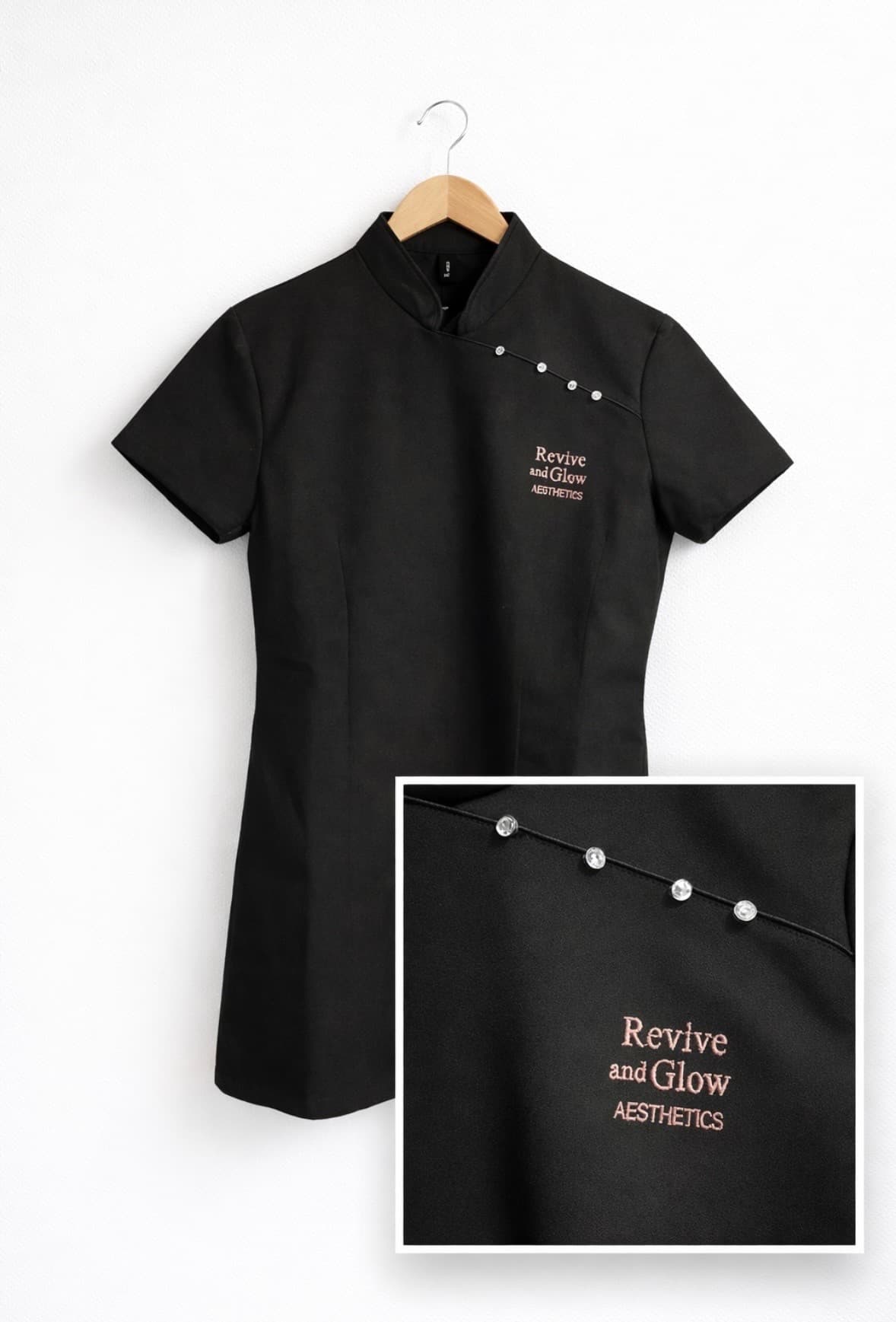 Black salon tunic embroidered by Burbage Embroidery & Print Room, with a close-up of the stitched logo